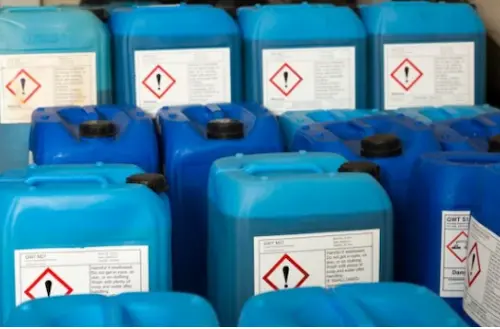 Eight containers of boiler water treatment chemicals displayed in two rows of four.