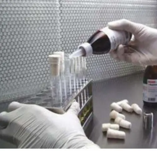 Laboratory technician performing industrial boiler water analysis to test water quality parameters.
