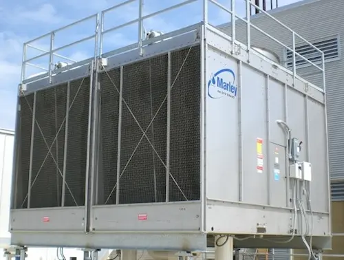 Operational industrial cooling tower system integrated with a comprehensive chemical water treatment program.