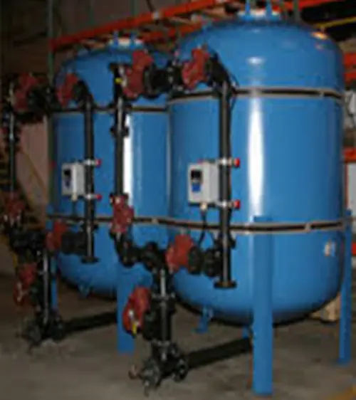 Two carbon steel multi-media filter tanks featuring exterior face piping and automated steel pneumatic valves.
