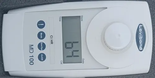 Digital photometer displaying the residual chlorine value in milligrams per liter during a water disinfection process.