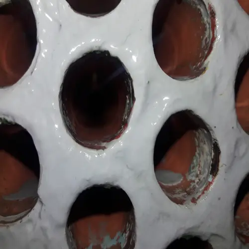Closeup of clean copper tubes inside an HVAC condenser after a successful tube cleaning service.