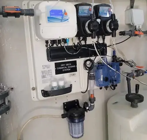 Water treatment controller with sensors for continuous water quality monitoring and two chemical tank-mounted dosing pumps.
