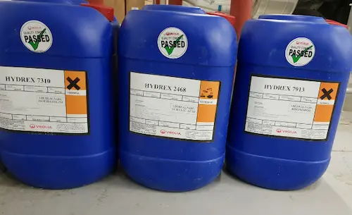 Display of industrial cooling water treatment chemicals including corrosion inhibitors, scale inhibitors, and biocides.