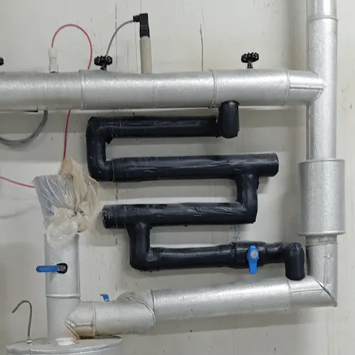 Corrosion coupon rack installed on a closed-loop chilled water system for water quality monitoring.