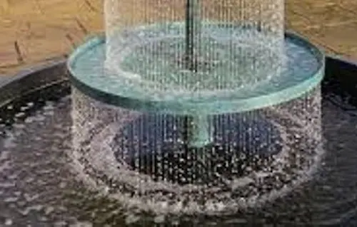 A modern water fountain with streams falling into a basin