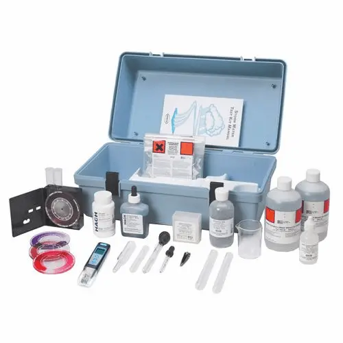 Water analysis test kit with drop test reagents, color charts, and sample vials completely on display.