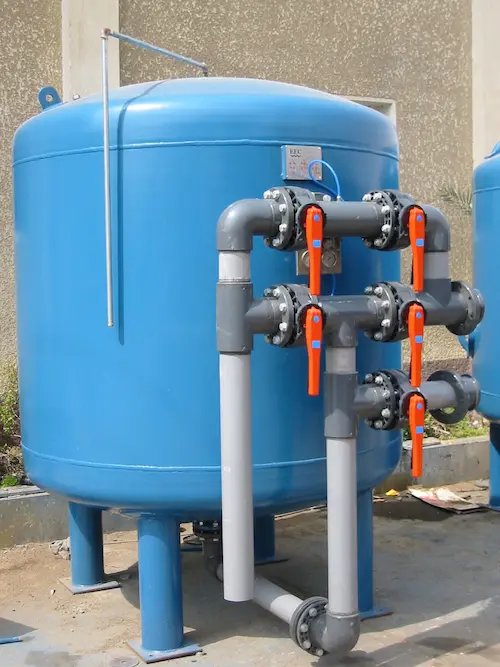 Carbon steel pressure filter vessel equipped with custom exterior face piping and manual control valves.
