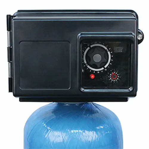 Automatic carbon filter control valve fitted on top of a water softener resin tank.