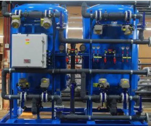 Fully automated demineralization plant showing the cation and anion resin tanks, control valves, and electrical control panel.