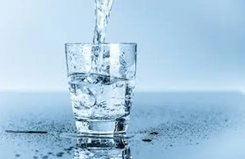 Sparkling clear drinking water in a glass, demonstrating the importance of professional water analysis.