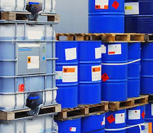 Pallets of industrial water treatment chemicals stacked up inside a chemical storage warehouse.